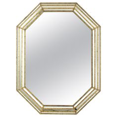 an octagonal mirror with gold trimmings on the edges and sides, against a white background