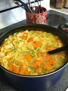 a pot filled with soup sitting on top of a stove