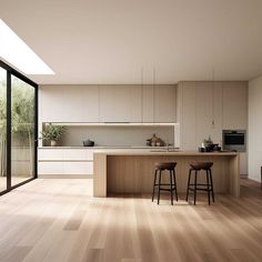 an open kitchen and dining area with wooden floors