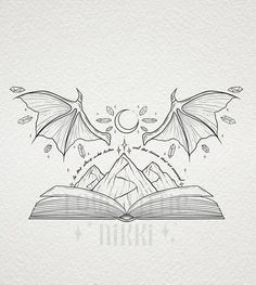 an open book with two dragon wings flying over it