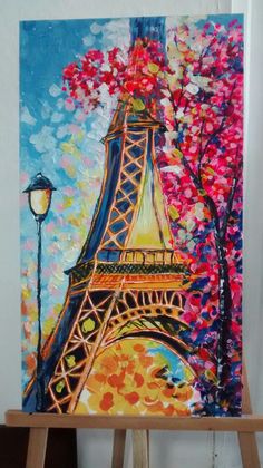 a painting of the eiffel tower in paris, france on an easel