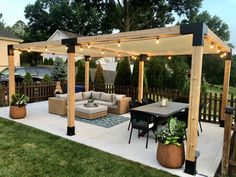 an outdoor living area with patio furniture and string lights on the pergolated roof