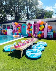 an inflatable pool is set up for a birthday party with balloons and decorations