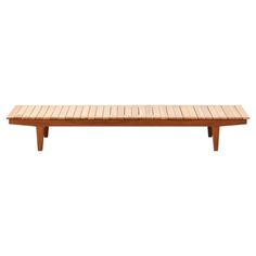 a wooden bench sitting on top of a white wall