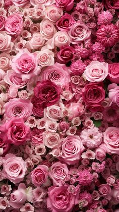 pink and white flowers are arranged together in the shape of a flower arrangement on display