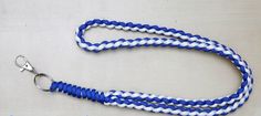 a blue and white lanyard with a metal hook