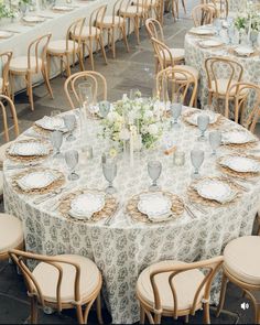 the table is set with many plates and silverware