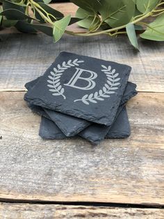 three slate coasters with the letter b on them