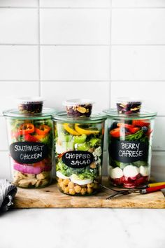 four jars filled with different types of food