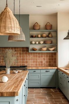 a kitchen filled with lots of counter top space next to a wooden counter topped with plates and bowls