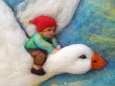 a needled picture of a boy riding on a white duck with the word slavin written below it