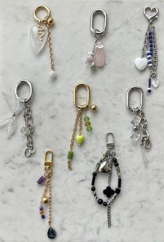 several different types of key chains on a marble surface