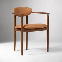 a wooden chair with tan leather upholstered on the back and armrests