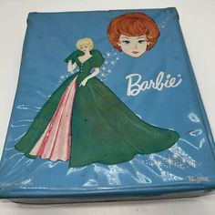 a book with an image of a woman in a green dress and the words barbie written on it