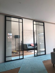 an empty living room with sliding glass doors on the wall and couch in the corner