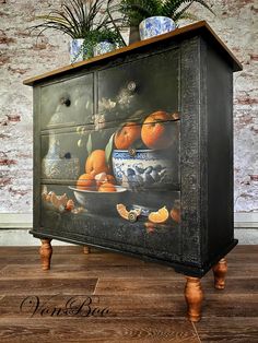 an old dresser with oranges painted on it