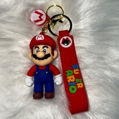 a nintendo keychain with an image of mario on it and the word super mario