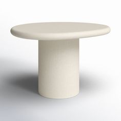 a white round table sitting on top of a floor