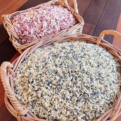 two wicker baskets filled with different types of food on top of a wooden floor