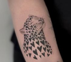 a black and white drawing of a cheetah with hearts on it's arm