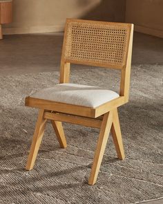 a wooden chair sitting on top of a carpeted floor