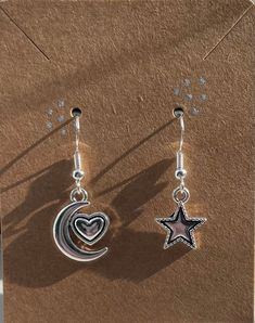 These cute and affordable star and moon earrings are great with any outfit. Made of sterling silver. Cute Star Charm Dangle Earrings, Cute Dangle Earrings With Star Charm, Trendy Silver Star Earrings, Cute Dangle Jewelry With Star Charm, Trendy Silver Star Charm Earrings, Trendy Silver Earrings With Star Charm, Moon Charm Star Earrings As Gift, Moon Charm Star-shaped Earrings For Gifts, Star-shaped Moon Charm Earrings For Gift