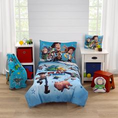 a bedroom with toy story bedding and toys on the floor in front of it