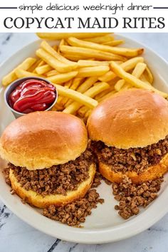 two sloppy joes on a plate with fries and ketchup