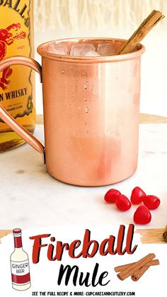 a copper mug with cinnamon sticks in it next to bottles of fireball mules