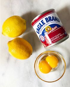 two lemons and an open can of eagle brand yogurt on a table