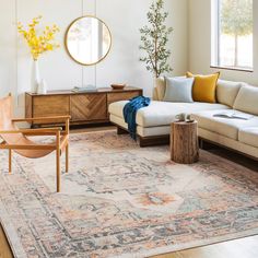 a living room filled with furniture and a large rug