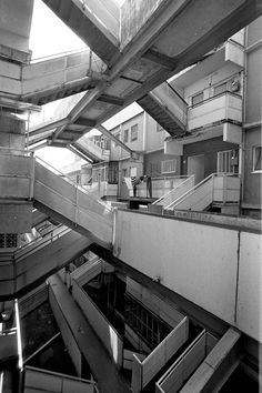 black and white photograph of an apartment building with multiple balconies on the roof