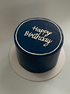 a blue birthday cake with the words happy birthday on it's top and bottom