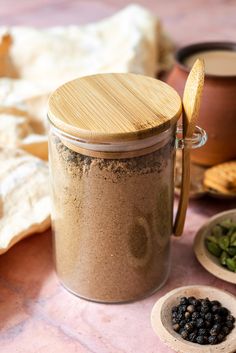 a jar filled with blackberries next to other spices