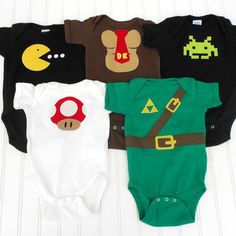 four baby onesuits with mario and luigi on them, all in different colors