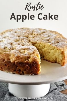 a cake on a white plate with the words rustic apple cake in front of it