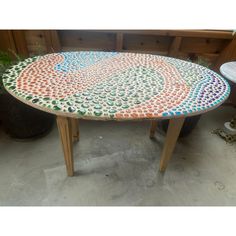 a table made out of different colored pebbles