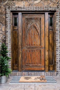 a large wooden door sitting on top of a stone building