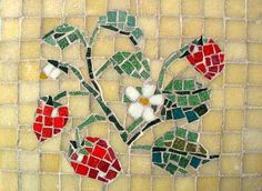 a mosaic tile with flowers and leaves on the bottom, in shades of green, red, yellow and white