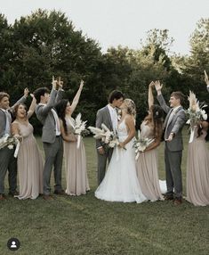 a group of people standing next to each other on top of a lush green field