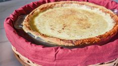 a pie sitting on top of a red cloth covered basket