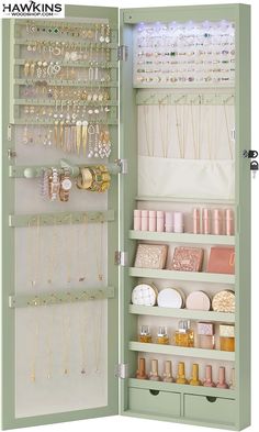 the inside of a green jewelry cabinet filled with lots of necklaces