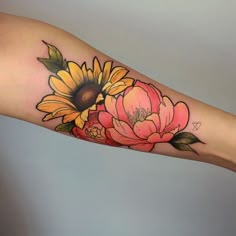 a sunflower and flower tattoo on the arm