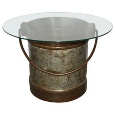 a round table with glass top and metal base