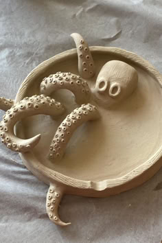 an octopus is sitting in a bowl on the table