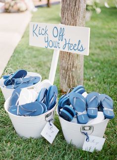 two buckets filled with blue plates next to a sign that says kick off your heels