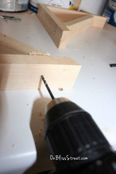 a drill is being used to attach wood pieces