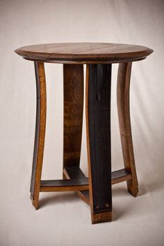 a round wooden table with two curved legs