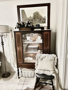 a room with a chair, table and pictures on the wall