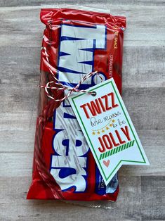 the candy bar is wrapped in plastic and has a tag that says, twinz we're jollyy